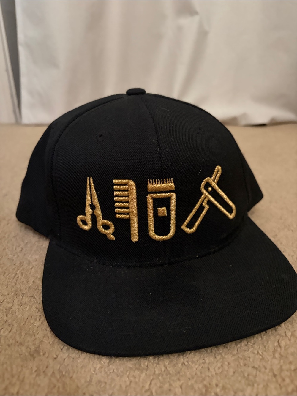 The Classic Black Cap with Gold Embroidered Grooming Icons